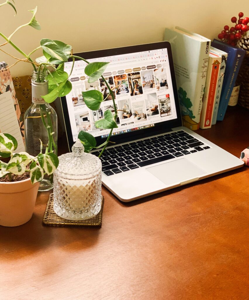 pexels-akshata-bablad-70197996-8367146 Cozy creative workspace with laptop, plants, books, and candle on wooden desk — Clear Path Studio calm design aesthetic.