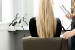 Straight blonde hair styled in a salon chair