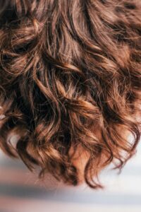 Voluminous dark brown curls styled with texture