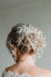 Curly updo hairstyle with a decorative hair accessory