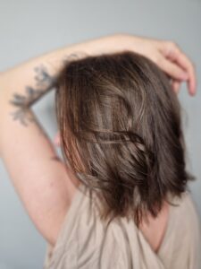 Tousled dark brown wavy hair, back view