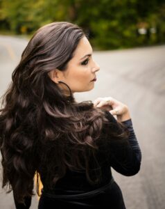 Woman with layered brunette waves looking to the side